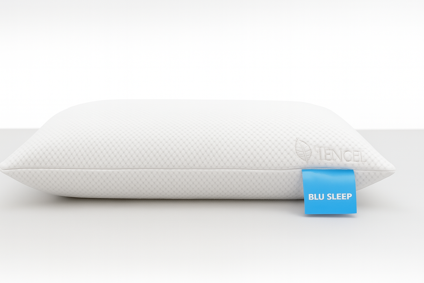 White pillow with a blue tag labeled 'BLU SLEEP' on a white background