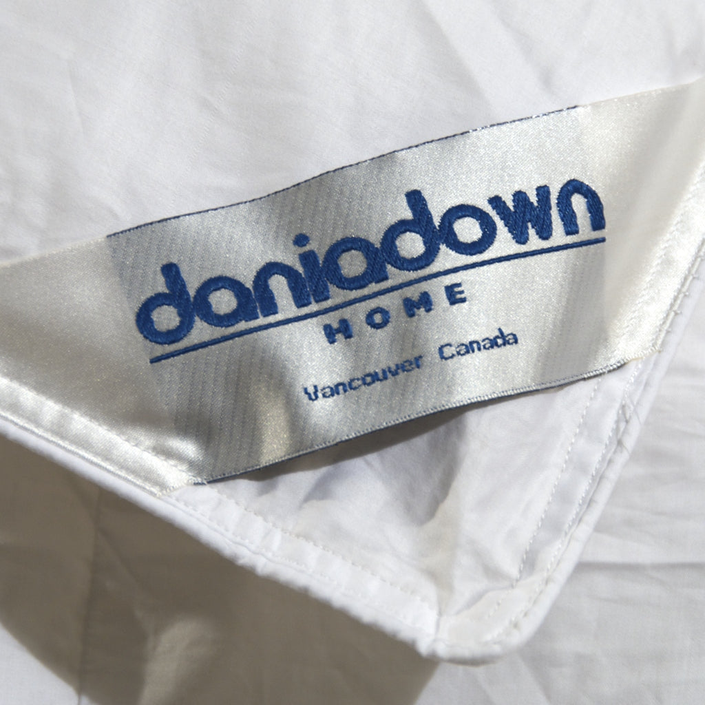Close up of the brand Daniadown tag in the Acadia Down Duvet