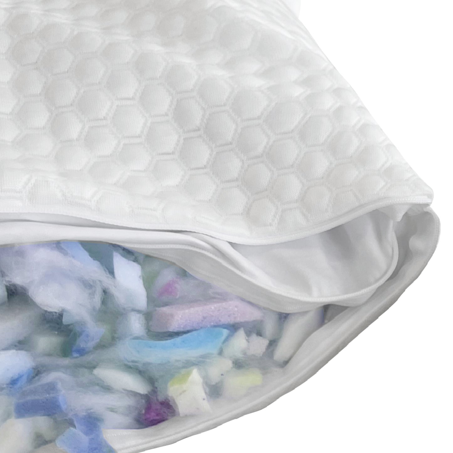 Close-up of GhostBed white pillow with a textured surface, showing a small opening revealing colorful items inside.