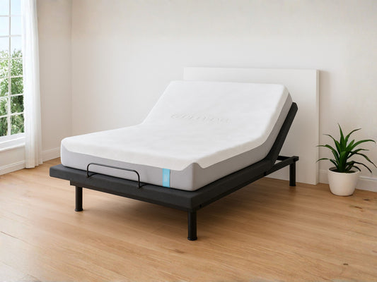 Mattress on a adjustable bed frame in a room with a window and plant.