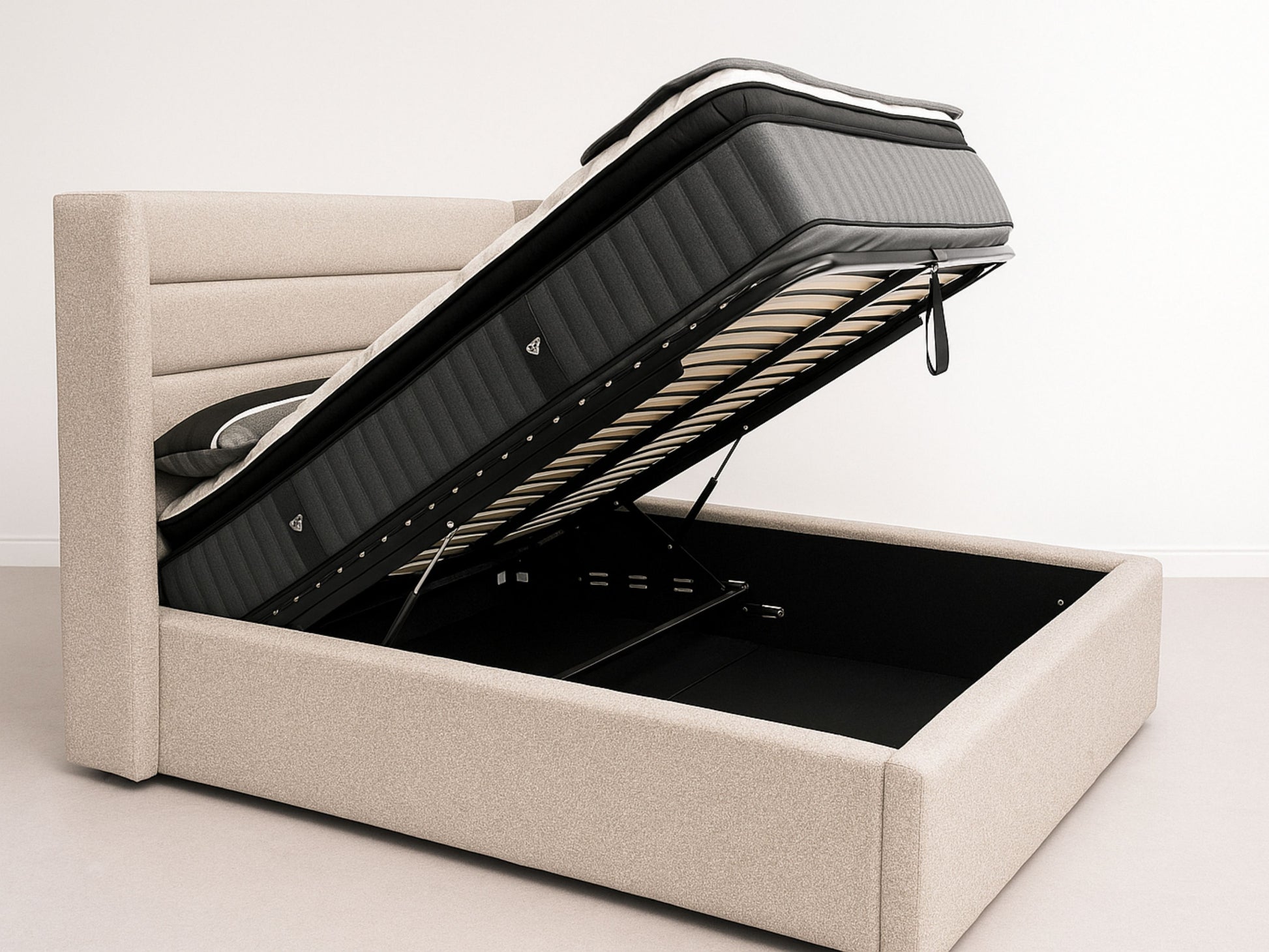 Beige upholstered bed with open storage compartment on a white background