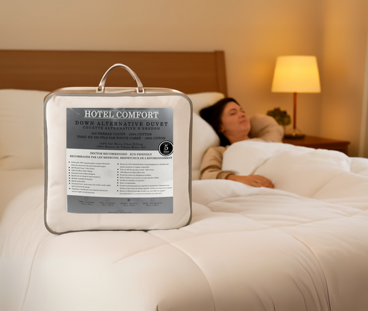 Hotel Comfort duvet in a packaging bag with a person lying in bed in the background