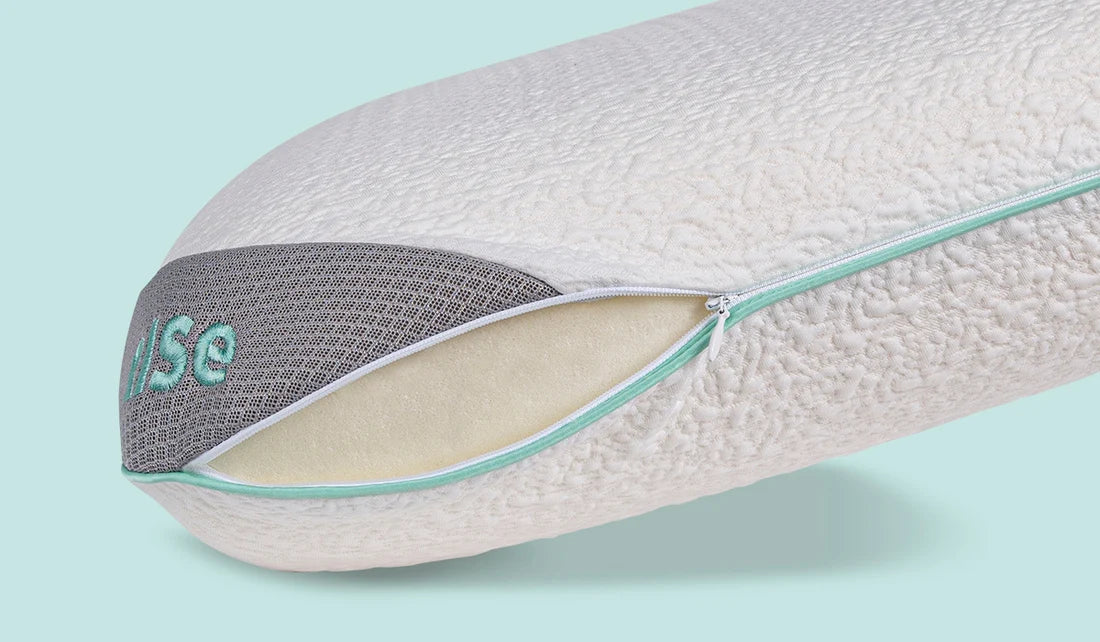 Ergonomic pillow with visible brand logo on a light blue background