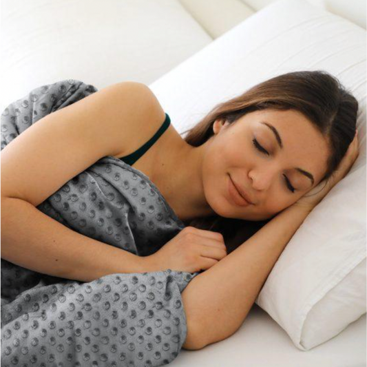 Woman using the Lotus Plush Weighted Blanket while sleeping